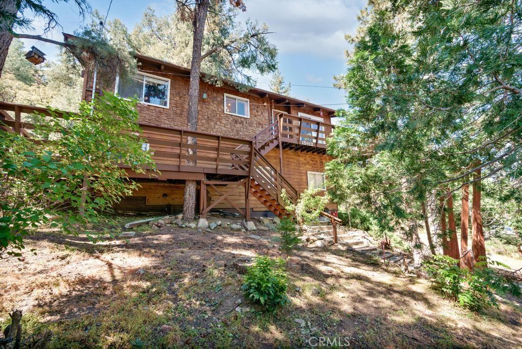 rear view of house featuring stairway and a wooden deck