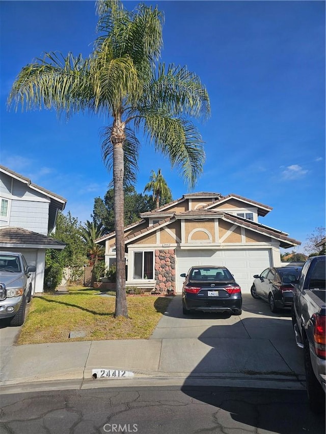 view of front of home featuring a front lawn and a garage