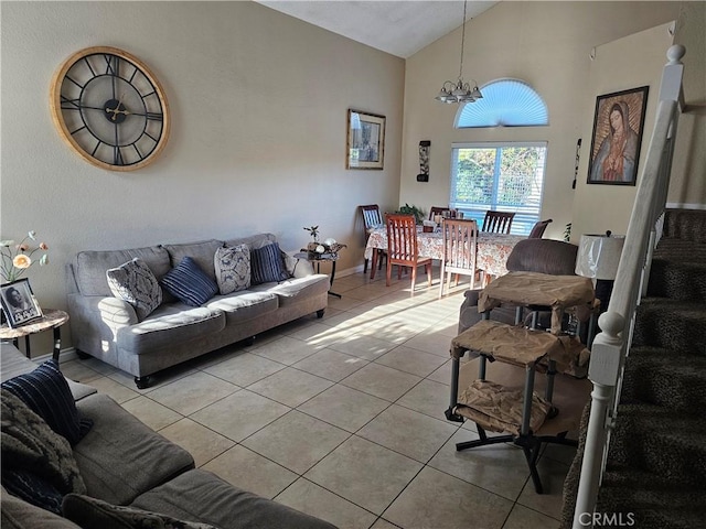 tiled living room featuring high vaulted ceiling and a notable chandelier