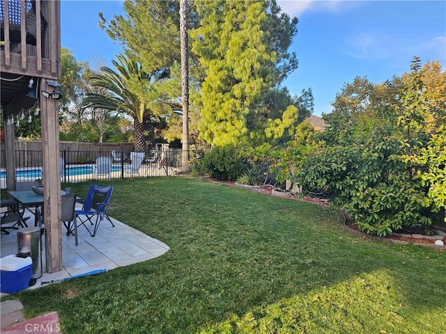 view of yard featuring a fenced in pool and a patio area