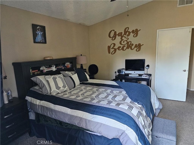 bedroom with carpet floors and a textured ceiling