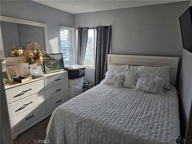 carpeted bedroom with a textured ceiling