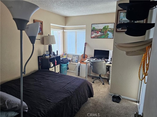 carpeted bedroom featuring a textured ceiling