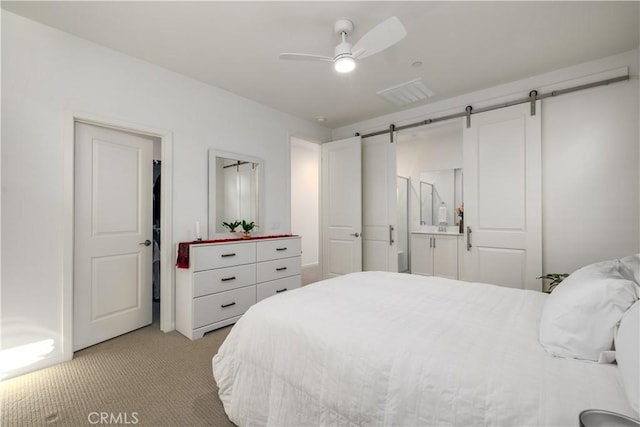 32879 Brunello Way, Temecula, CA 92591 - bedroom with light carpet, a barn door, and a ceiling fan