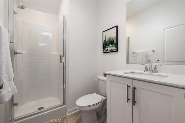 bathroom with toilet, vanity, walk in shower, and hardwood / wood-style flooring