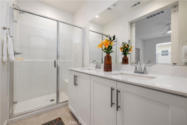 bathroom with walk in shower, ceiling fan, tile patterned floors, and vanity