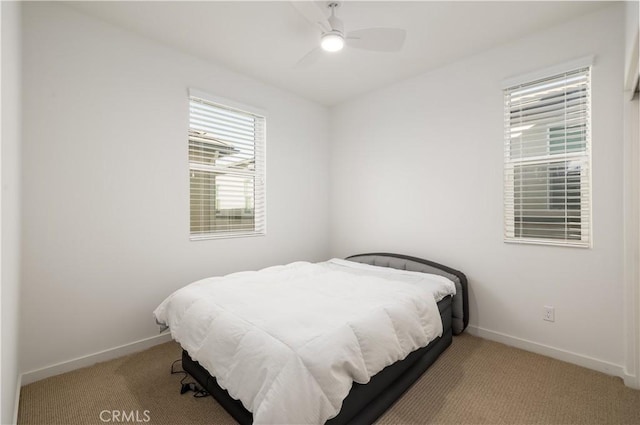 bedroom featuring ceiling fan and light carpet