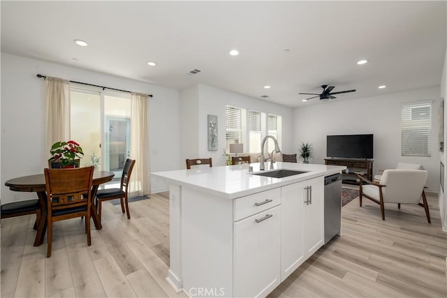 32879 Brunello Way, Temecula, CA 92591 - kitchen featuring stainless steel dishwasher, light wood finished floors, light countertops, recessed lighting, and an island with sink