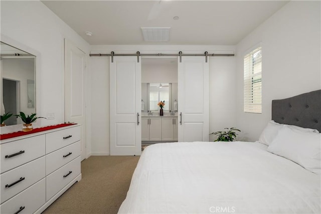 32879 Brunello Way, Temecula, CA 92591 - bedroom featuring a barn door, light carpet, and ensuite bathroom