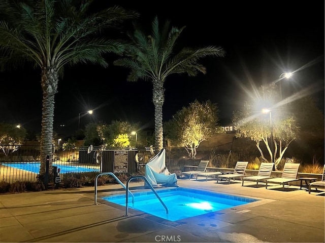 pool at night with a patio