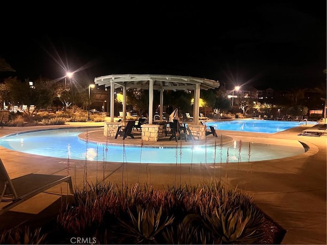 pool at twilight with a patio