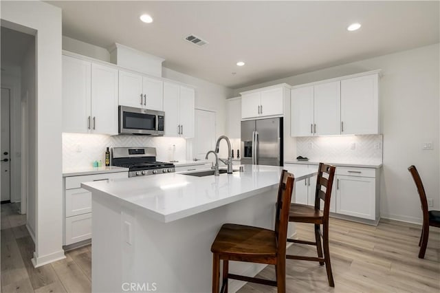 kitchen featuring appliances with stainless steel finishes and white cabinets