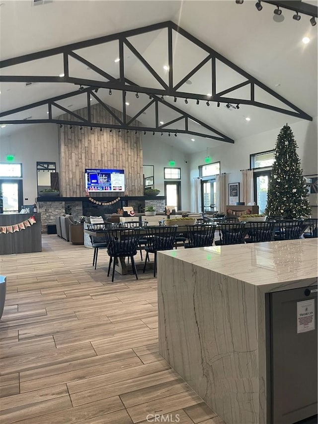 kitchen featuring light stone countertops and lofted ceiling with beams