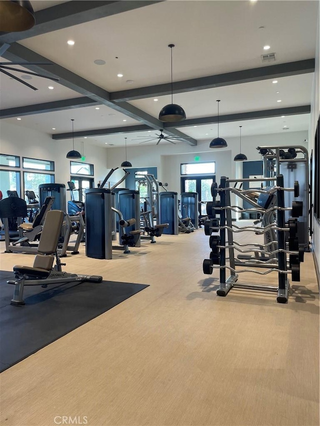 exercise room with light carpet and ceiling fan