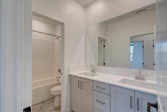 full bathroom featuring tile patterned flooring, vanity, toilet, and shower / tub combination