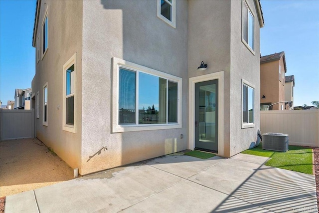 rear view of house with cooling unit and a patio area