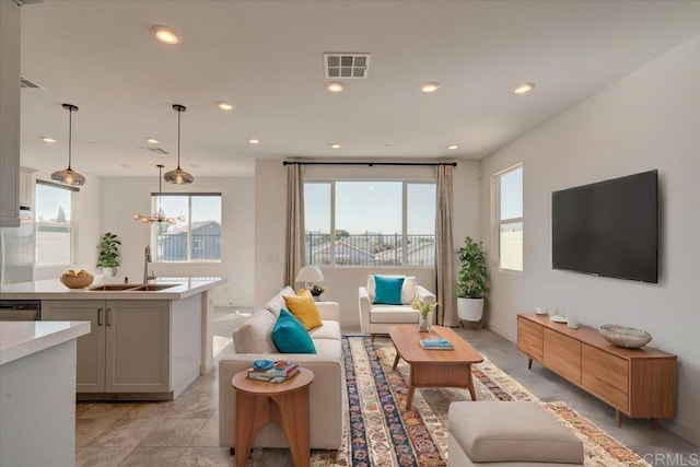 living room featuring sink and a chandelier