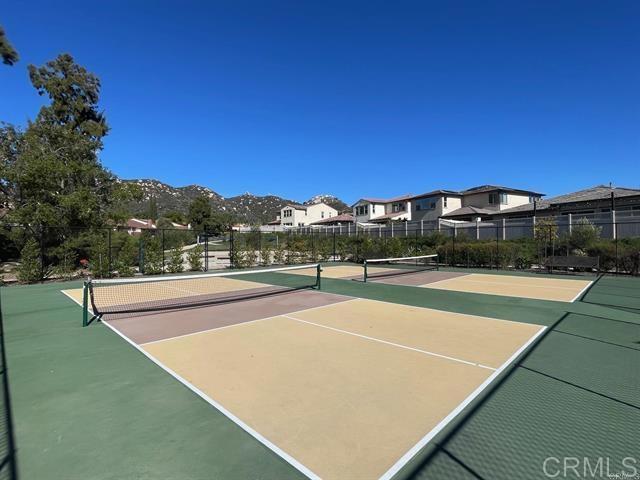 view of tennis court featuring basketball court