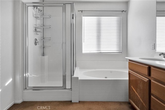 bathroom featuring vanity and shower with separate bathtub