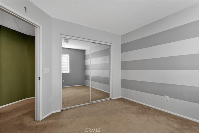 unfurnished bedroom featuring a closet and carpet floors