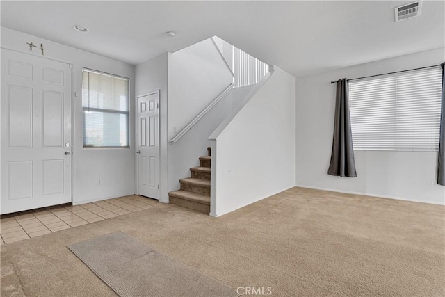 foyer entrance with light carpet