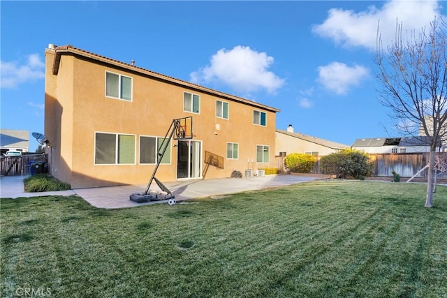 back of property featuring a yard and a patio