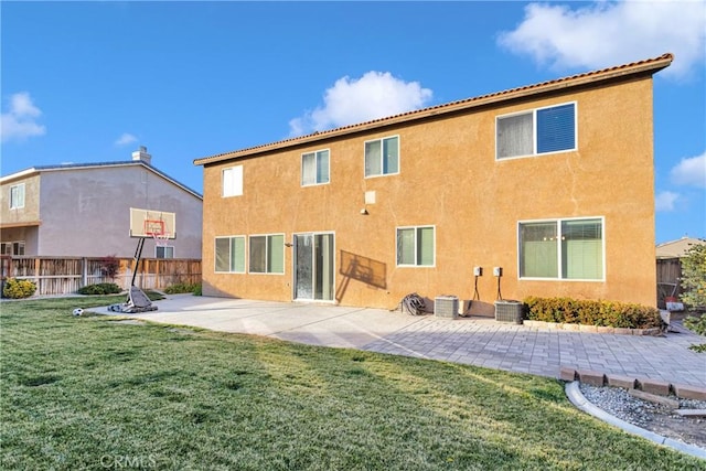 rear view of property with a lawn and a patio area