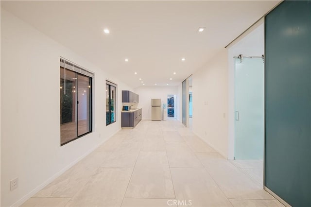 hallway featuring light tile patterned floors