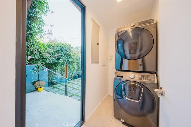 washroom with light tile patterned floors and stacked washer and clothes dryer