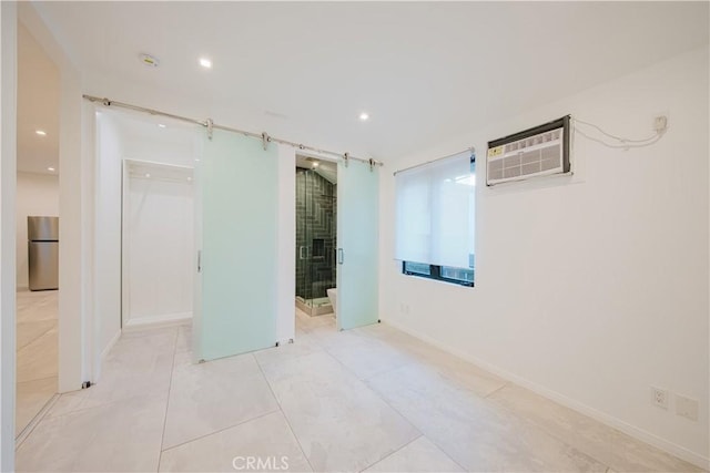 tiled spare room featuring a wall mounted air conditioner