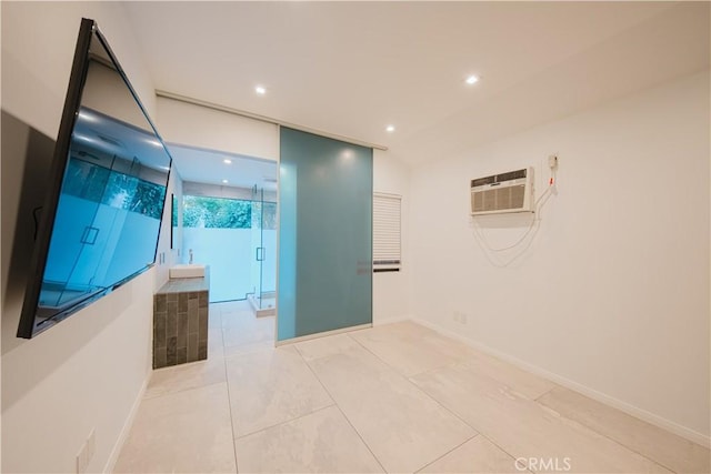 hallway featuring light tile patterned floors and a wall unit AC