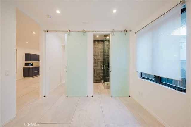 hallway featuring light tile patterned floors