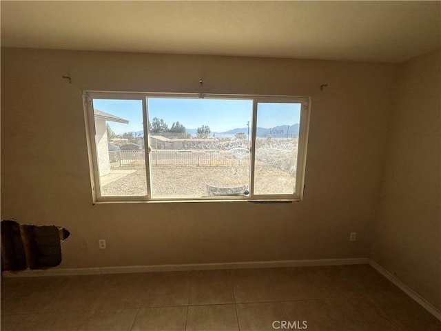 tiled empty room featuring a mountain view