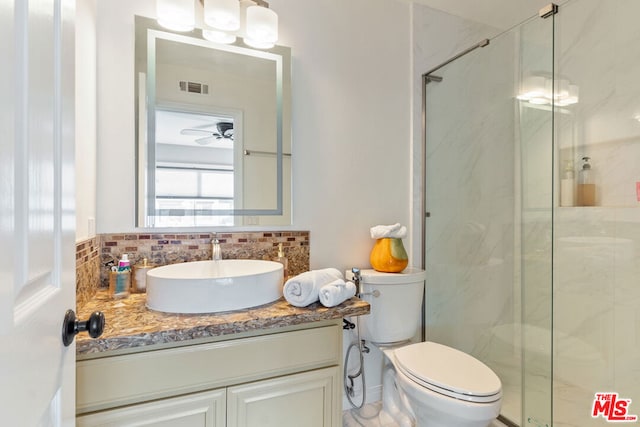 bathroom with decorative backsplash, vanity, toilet, and an enclosed shower