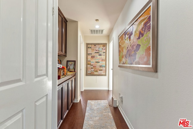 hall with dark hardwood / wood-style flooring