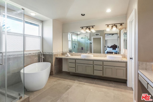 bathroom with vanity, plus walk in shower, tile patterned floors, ceiling fan, and tile walls