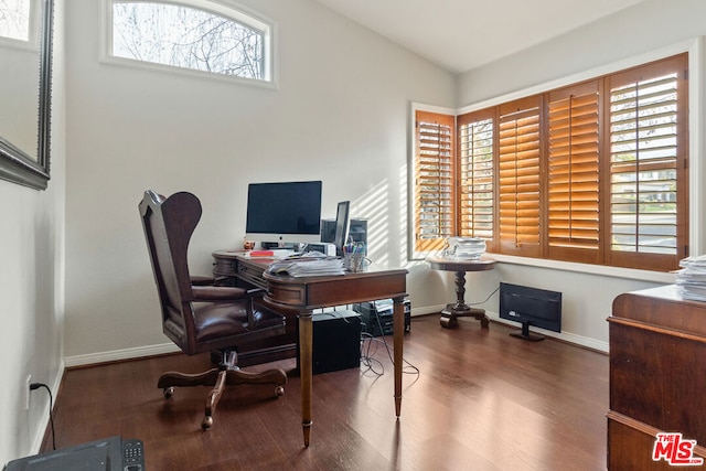 home office featuring hardwood / wood-style floors and vaulted ceiling