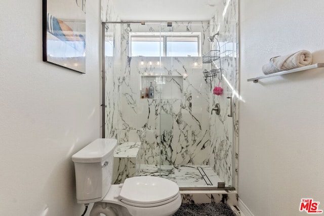 bathroom featuring a tile shower and toilet