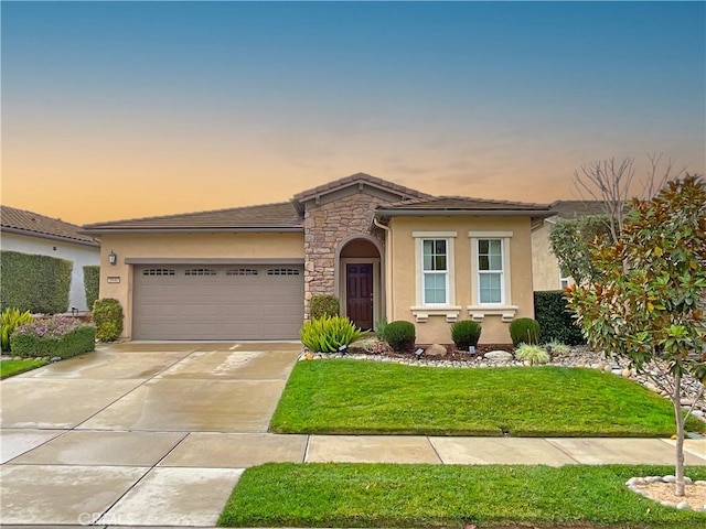 view of front of home featuring a garage and a yard