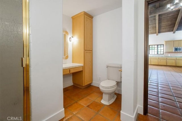 bathroom featuring tile patterned floors, toilet, and walk in shower