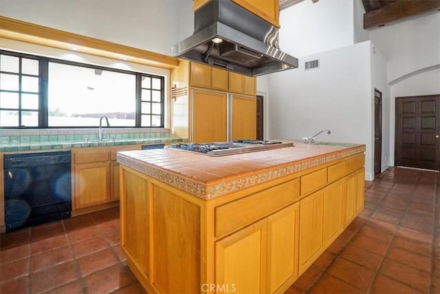 kitchen featuring sink, black dishwasher, tile countertops, a center island, and range hood