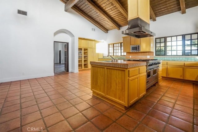 kitchen with wooden ceiling, high vaulted ceiling, a center island with sink, appliances with stainless steel finishes, and beamed ceiling