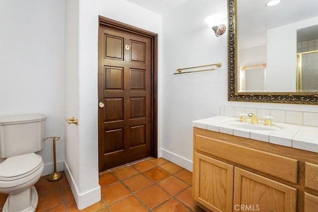 bathroom with tile patterned flooring, vanity, toilet, and an enclosed shower