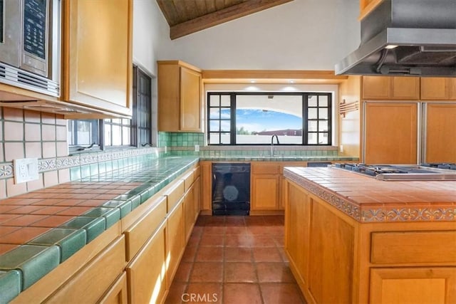 kitchen with island exhaust hood, tasteful backsplash, stainless steel appliances, vaulted ceiling, and tile countertops