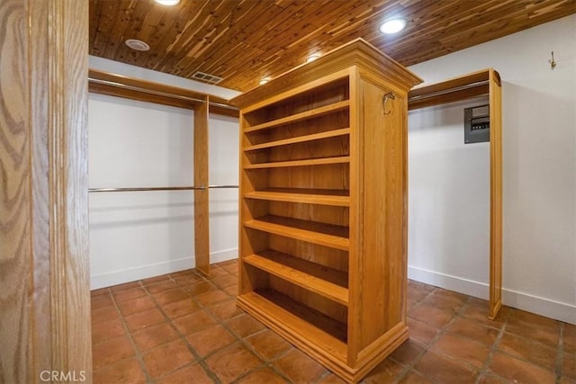 walk in closet with tile patterned floors