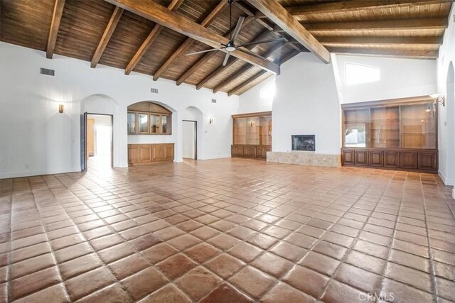 unfurnished living room featuring wooden ceiling, high vaulted ceiling, tile patterned flooring, ceiling fan, and beamed ceiling