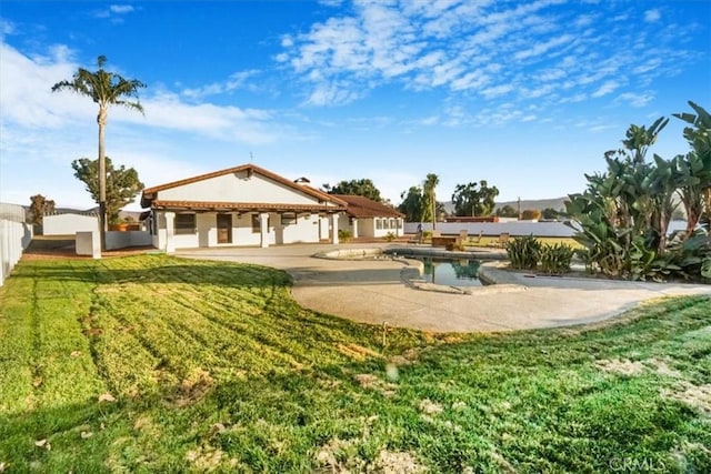 exterior space featuring a patio, a fenced in pool, and a lawn