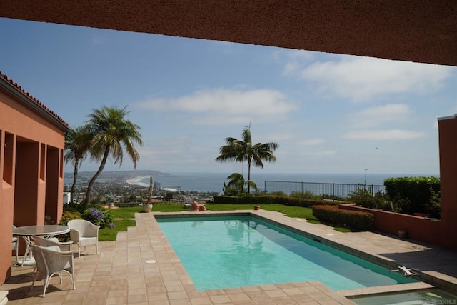 view of pool featuring a water view and a patio area