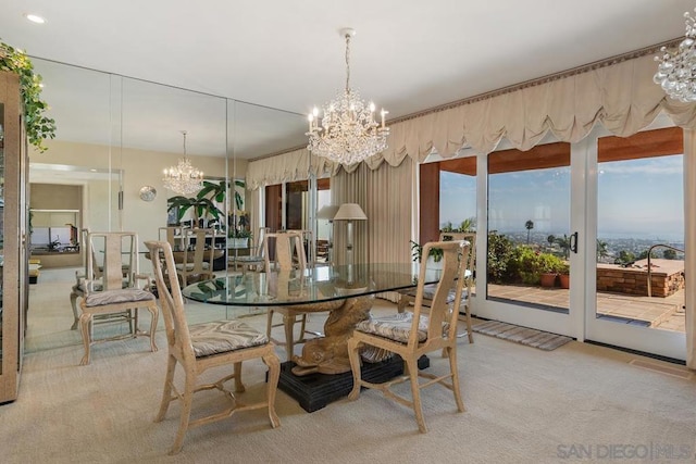 carpeted dining space featuring a chandelier