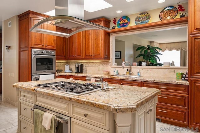 kitchen with sink, backsplash, island exhaust hood, a kitchen island, and appliances with stainless steel finishes